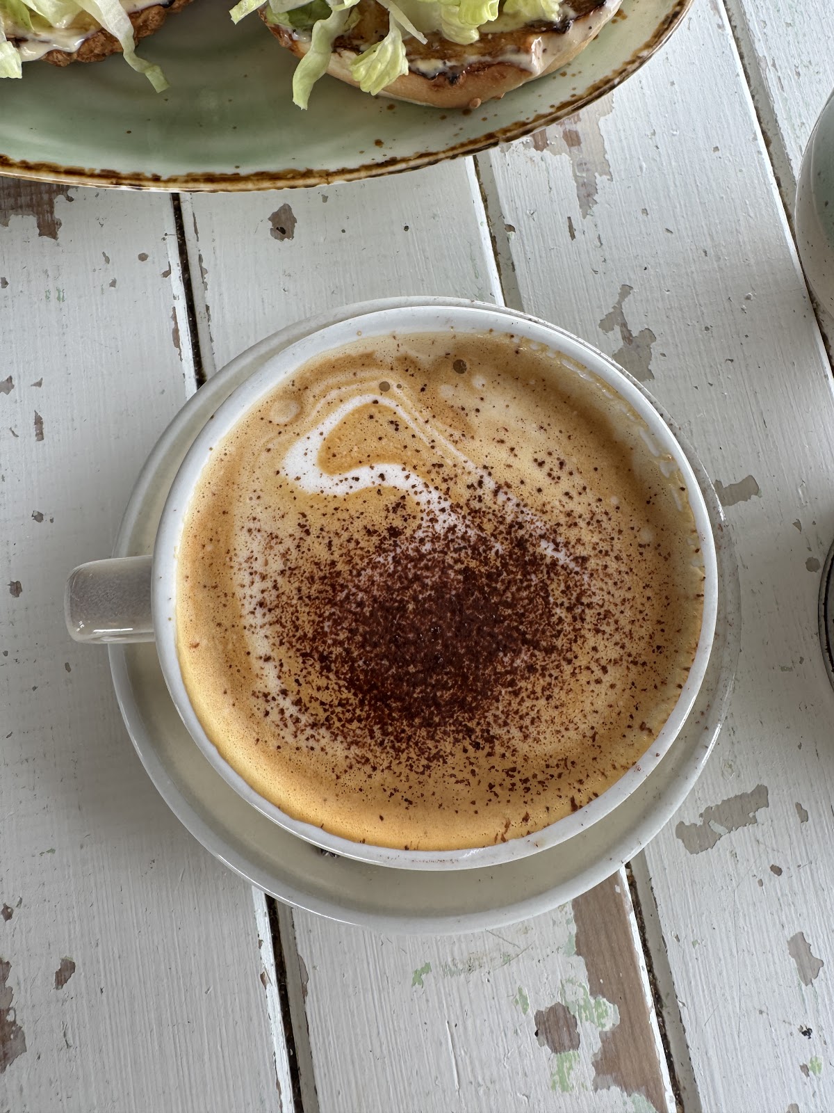 Cappuccino on the white washed table
